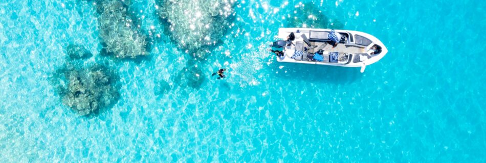 A Boat on Blue Body of Water